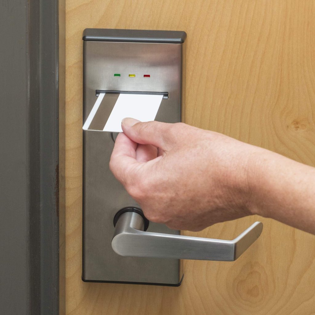 An image of a key card being used to open a door that uses access control systems