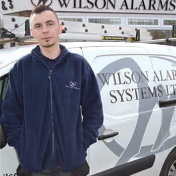 An image of a Wilson Alarm Systems employee named Gracjan Nogaj