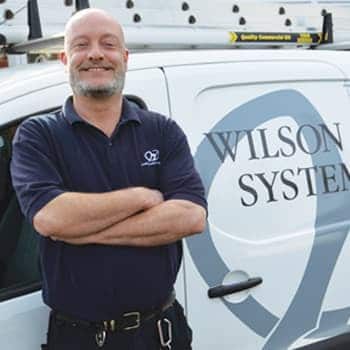 An image of a Wilson Alarm Systems employee named Woolman