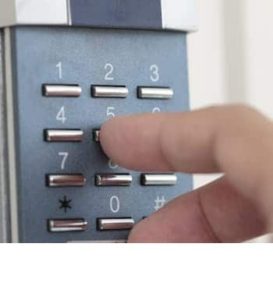 A close up image of someone pressing an access control keypad