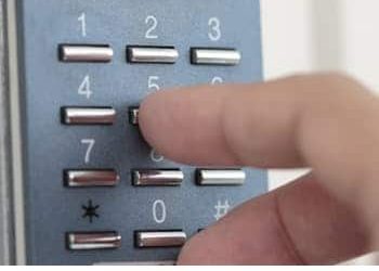 A close up image of someone pressing an access control keypad