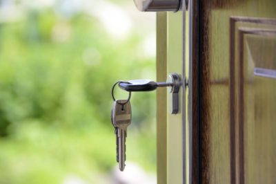 Keys in a lock on an open front door