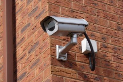 An image of a CCTV camera installed onto the side of a building