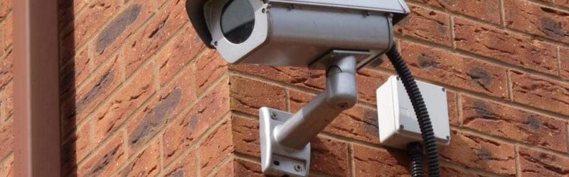 An image of a CCTV camera installed onto the side of a building