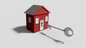 An image showing a secure toy house with a large key ready to open the door.