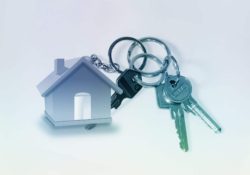 An image of a bunch of keys with a keyring in the shape of a house attached.