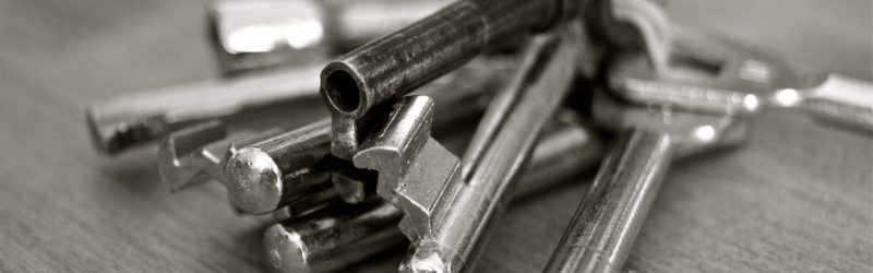 An image of a set of silver keys on a table in a house.