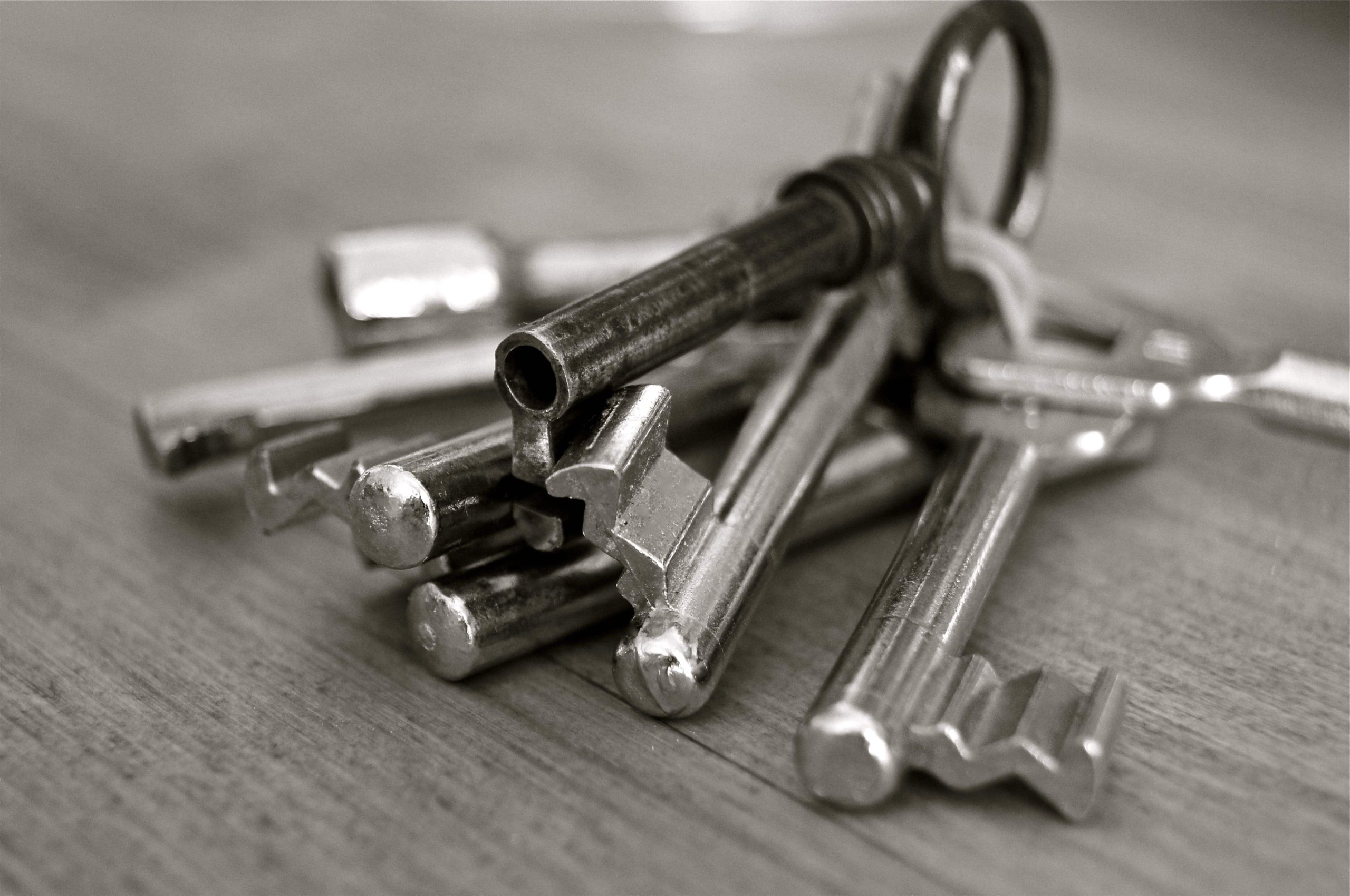 An image of a set of silver keys on a table in a house.